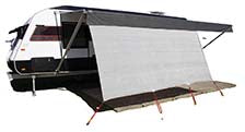 A modern, black and white travel trailer with a large, extended awning features the Explore Caravan Privacy Screen 1.8m X 4.9m by Explore, providing additional sun protection with its breathable mesh design. The trailer appears ready for outdoor camping adventures.