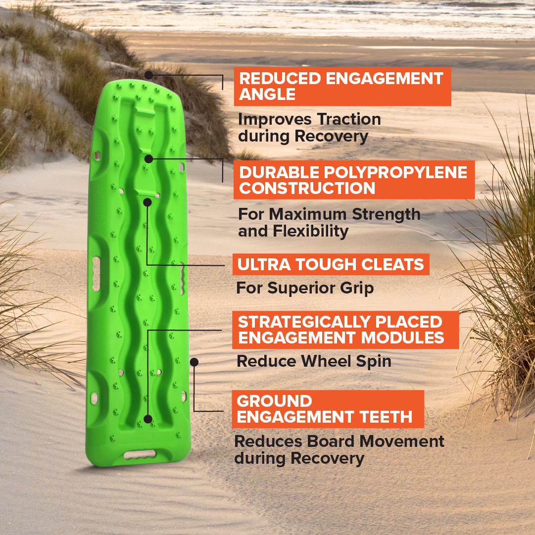 An Exitrax Recovery Board 1110 Series - Metallic Lime Green, Pair (Trade Show Only) is showcased on a sandy beach with dunes in the background. The traction board boasts a reduced engagement angle, durable polypropylene construction, ultra-tough cleats, strategically placed engagement modules, and ground engagement teeth to minimize wheel spin. In addition, it comes with a lifetime warranty.