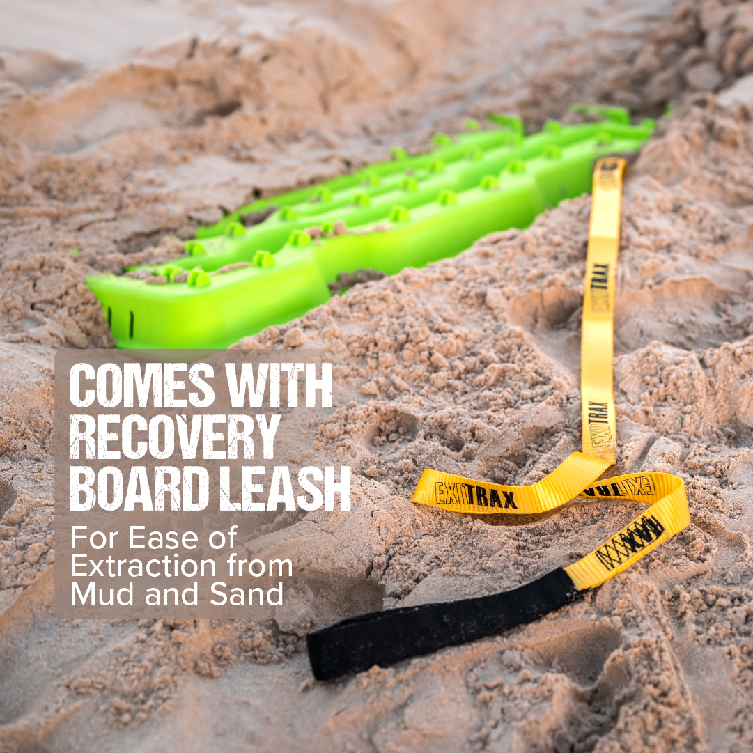 A vibrant Metallic Sunrise Red Exitrax Recovery Board 1110 Series lies on sandy ground, attached to a yellow and black leash. The text on the image reads, "Comes with Recovery Board Leash for Ease of Extraction from Mud and Sand" in large, white letters.