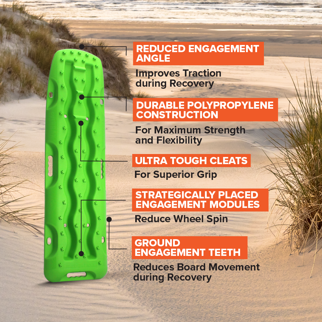 A Exitrax Recovery Board 1110 Series in Metallic Sunrise Red is displayed in a beach setting, showcasing labeled features such as reduced engagement angle, durable polypropylene construction, ultra-tough cleats, strategically placed engagement modules, and ground engagement teeth. Exitrax Recovery Boards ensure reliable performance.