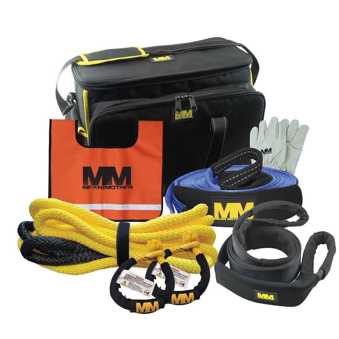 Introducing the Mean Mother Ultimate 8 Piece Recovery Kit, perfect for the 4WD enthusiast. This kit includes a black and yellow carrying bag emblazoned with the Mean Mother 4x4 logo, gloves, towing straps, a snatch strap, an orange tote bag, and two shackles. Each item is carefully arranged on a white background with MM branding prominently featured.