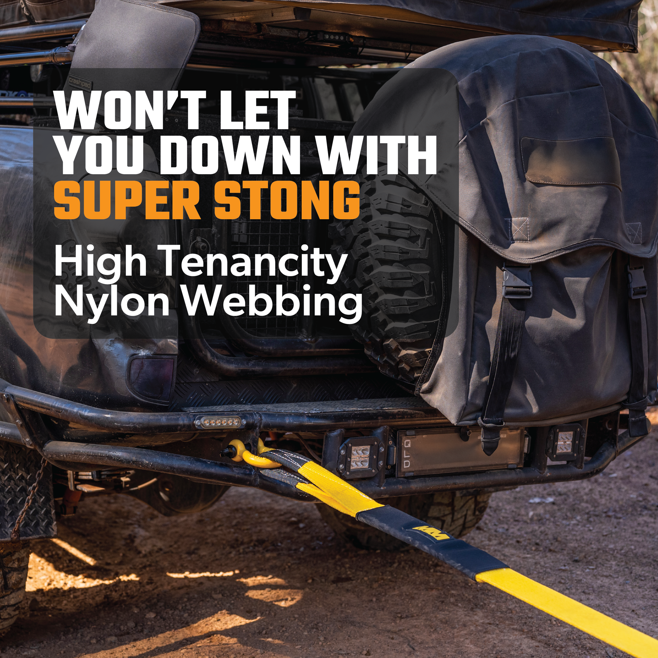 An adventure-ready vehicle showcases off-road essentials, such as a spare tire and the Snatch Strap 8,000kg from Mean Mother, neatly stored in a large black bag. The text states, "Won't let you down with super strong high tenacity nylon webbing," while a yellow nylon webbing is securely fastened to the vehicle.