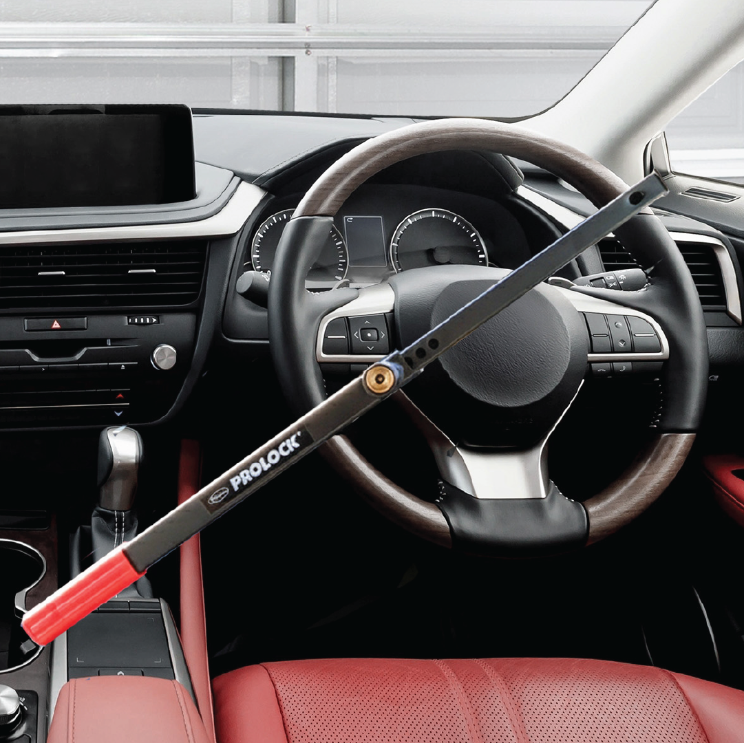 The Sperling Steering Wheel Lock Prolock with red handles is secured to the steering wheel of a modern car with a digital dashboard and red-black interior, boosting vehicle security as an effective anti-theft solution.