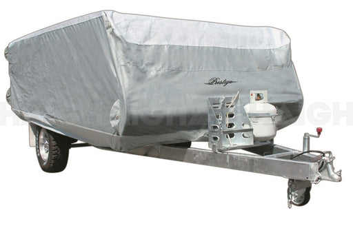 A caravan with a silver, triple-layered, waterproof cover branded "Prestige," featuring UV-stabilized material. This transport trailer includes a towing hitch and has a propane tank attached at the front. It is supported by two wheels and is ideal for transportation purposes.