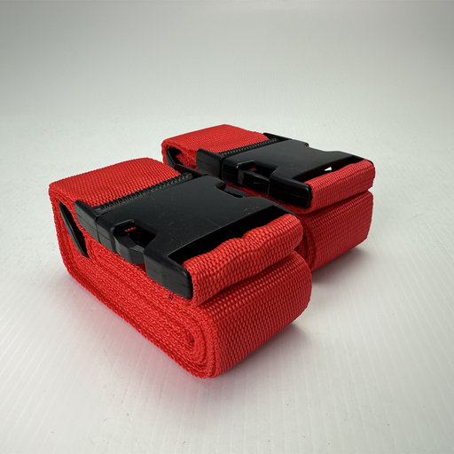 Two Mean Mother 4x4 Luggage Straps (2Pc, 2.8mm x 1 3/4") in red with large black plastic buckles are neatly rolled side by side on a white textured surface.