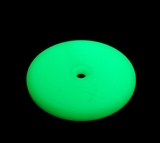 The Mean Mother 4x4 Glo X Round Marker Illuminator is a glowing green, disc-shaped device with a central hole, resembling a large button, displayed against a solid black background.