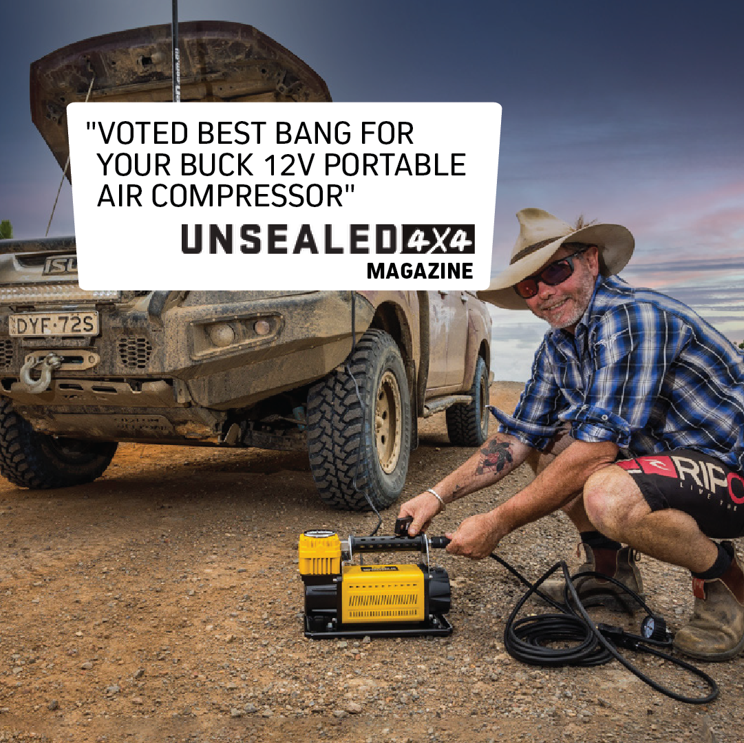 A person is kneeling beside an SUV on a dirt road, inflating a tire with the Mean Mother Air Compressor with Wireless Remote Control 180lpm, featuring powerful 180L/Min free air delivery. The sky is cloudy, and alongside the scene, there's a quote from Unsealed 4x4 Magazine highlighting the value of this compressor, which comes with an impressive 5-year warranty.