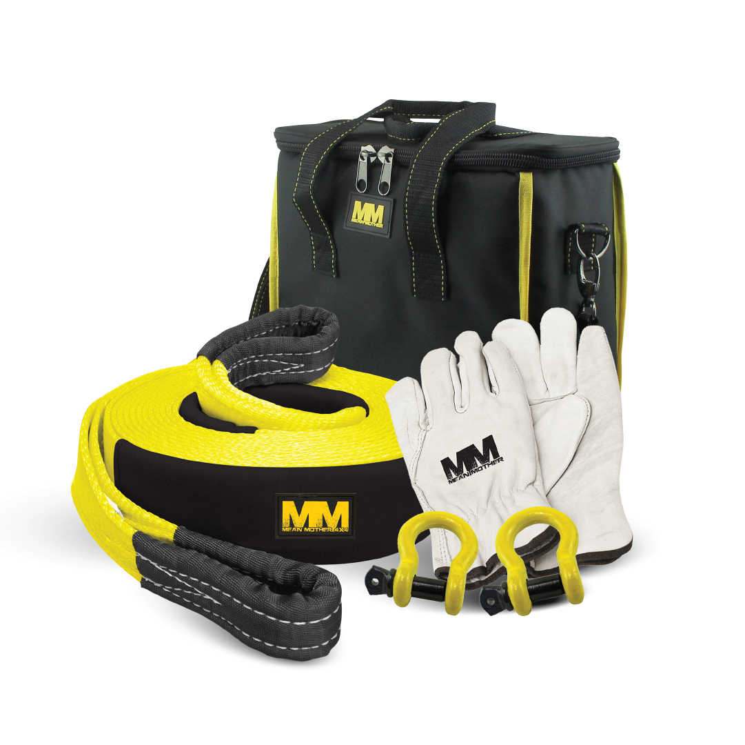 The Mean Mother 5pc Recovery Kit 8,000kg is perfect for the 4WD enthusiast. It comes in a stylish black and yellow carrying case with a handle and prominently features the "MM" logo. Inside, you'll find white gloves also marked with "MM," two durable yellow shackles, and a neatly coiled nylon snatch strap.