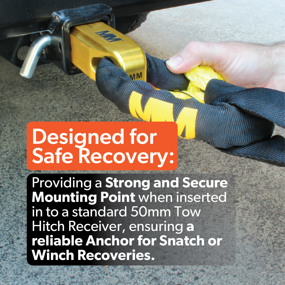 A gloved hand fits the Mean Mother 4x4 Recovery Hitch into a vehicle’s tow hitch receiver, highlighting its strong, secure mounting point for safe snatch or winch recoveries.