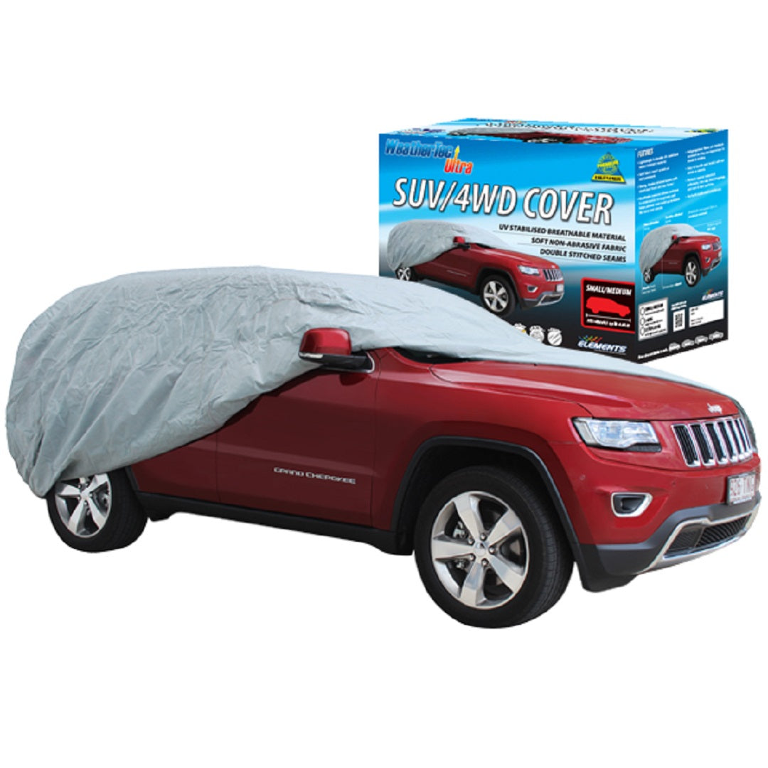 A red SUV is partially covered by a gray car cover from breathable fabric. In the background, you can see a box displaying the WeatherTec Ultra - Smaller 4wd/SUV's Up to 4.65m packaging and product details, highlighting its UV protection features.