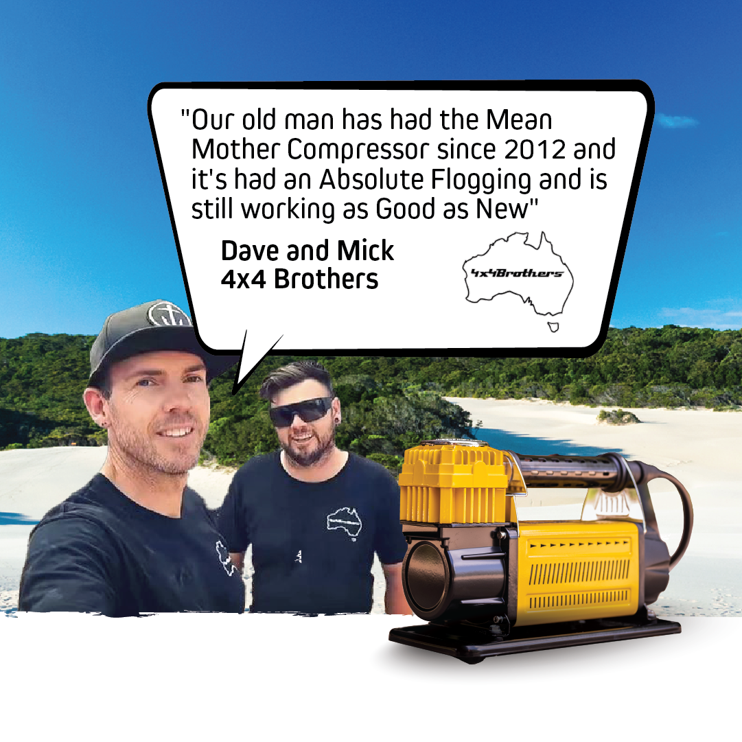 Two men on a sandy beach with trees behind them, one in a dark t-shirt and hat, the other in a black shirt and sunglasses, standing beside a yellow Mean Mother Adventurer 4 â€“ 180lpm Air Compressor Bundle. A speech bubble reads: "Our old man has had the Mean Mother Adventurer 4 since 2012 and it's had an absolute flogging and is still working as good as new" – Dave and Mick.